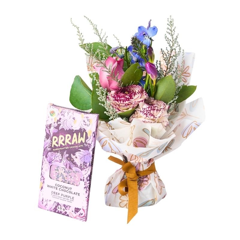Floral Fantasy Posy with vegan chocolate — petite pink-and-purple posy wrapped with ribbon beside a chocolate bar
