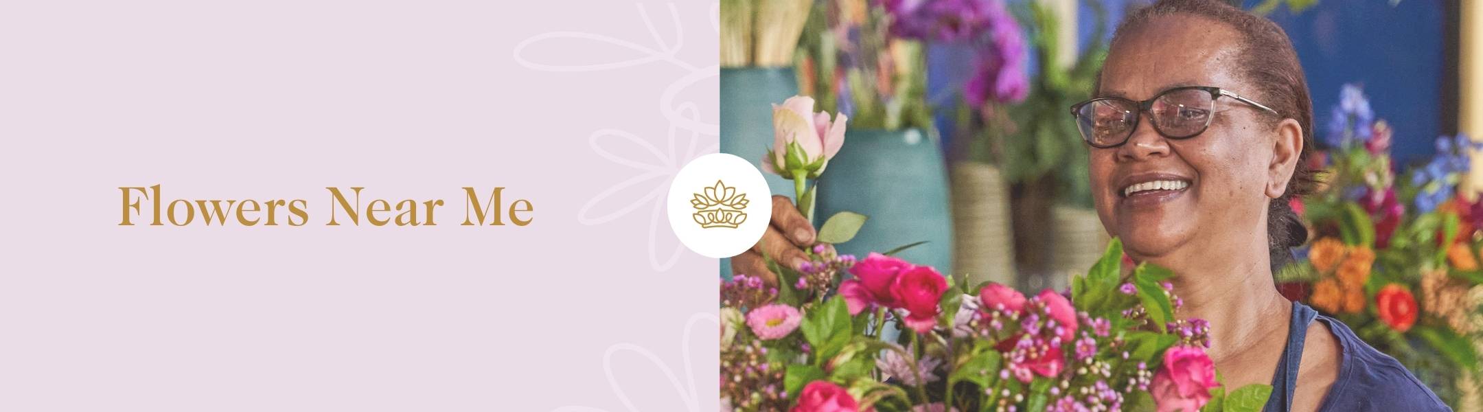 Smiling florist arranging colourful flowers, promoting local flower options with 'Flowers Near Me' text from Fabulous Flowers & Gifts.