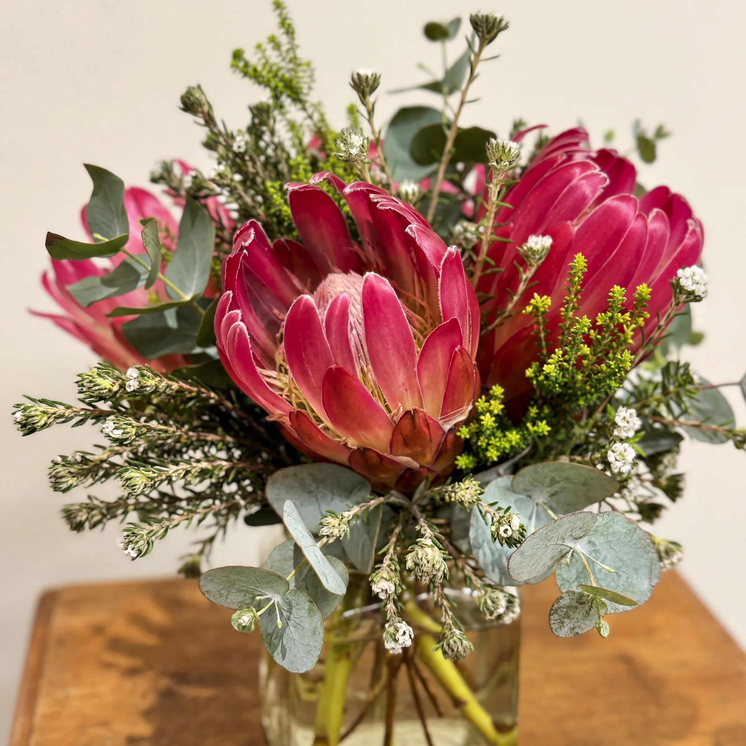 Close-up of pink protea, leucadendron and waxflower in the Fynbos in a Jar Cape native posy