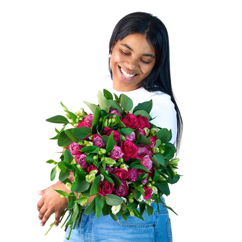 Woman holding a bouquet of pink and green flowers on a white background