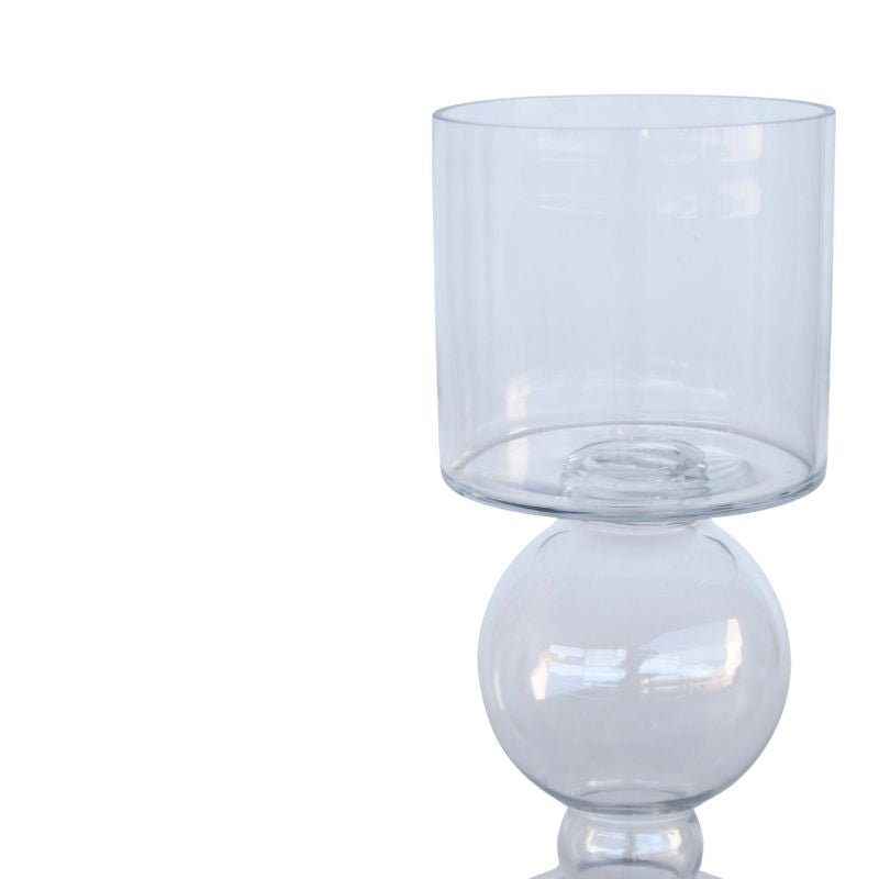 Clear glass candle holder with spherical base on a white background