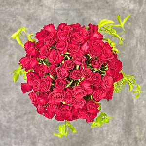 Romantic Golden Majesty arrangement of red roses for special occasions. Top shot of 100 red roses. - Fabulous Flowers and Gifts