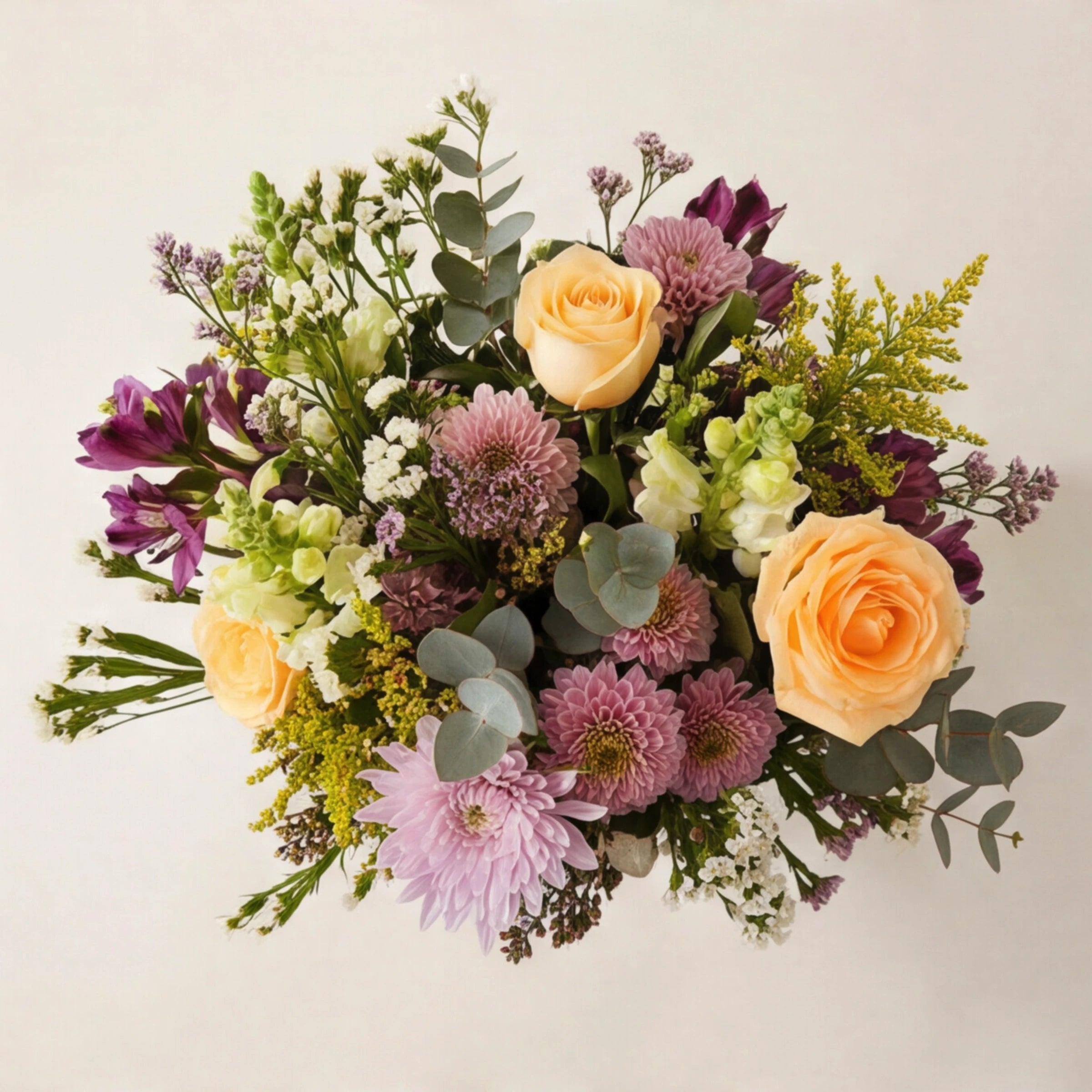 Overhead view of Grace in a Jar arrangement showing peach roses, lilac chrysanthemums, purple alstroemeria, white snapdragons, yellow solidago and silver dollar eucalyptus in a soft refined palette by Fabulous Flowers Cape Town.