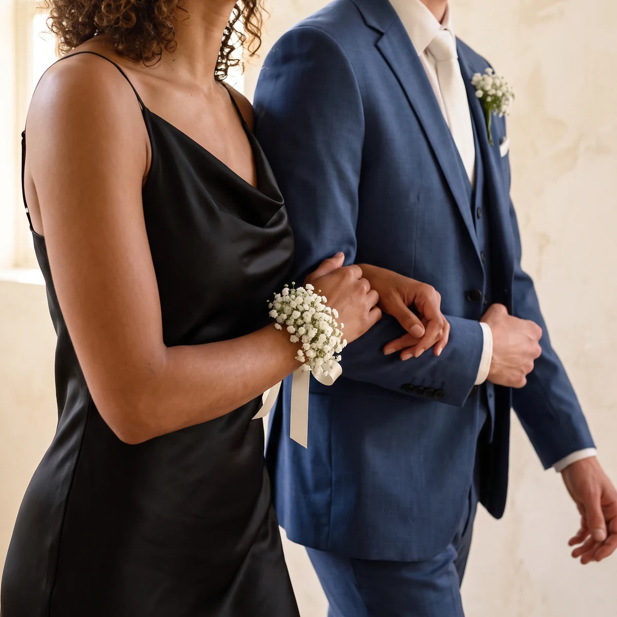 Couple arm in arm with a gypsophila wrist corsage and matching boutonniere, Fabulous Flowers South Africa