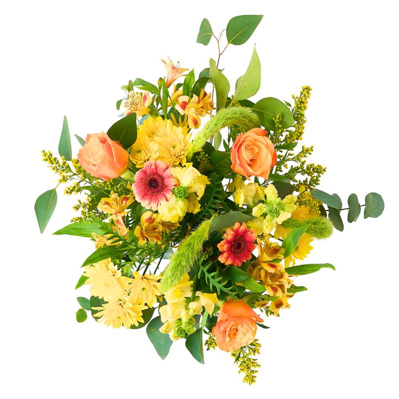 Colorful Jar arrangement of flowers in a clear glass vase on a white background of flowers with greenery