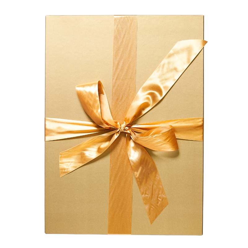 Gold satin ribbon bow on Her Majesty's Gift Box luxury packaging