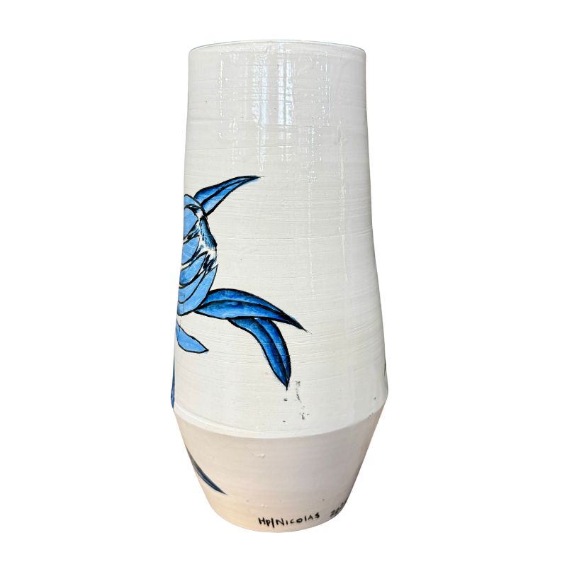 White ceramic vase with blue fish design on a white background