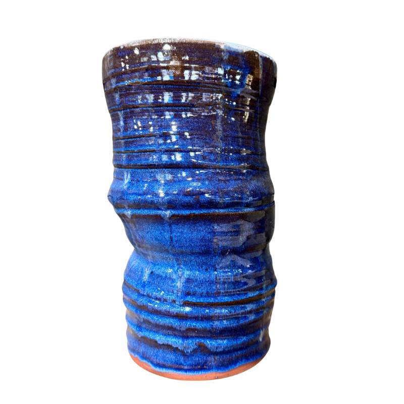 Blue ceramic vase with textured surface on a white background