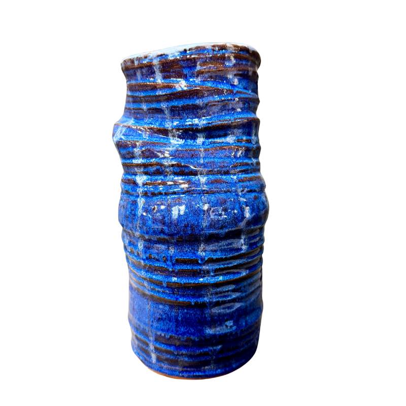 Blue ceramic vase with textured surface on a white background