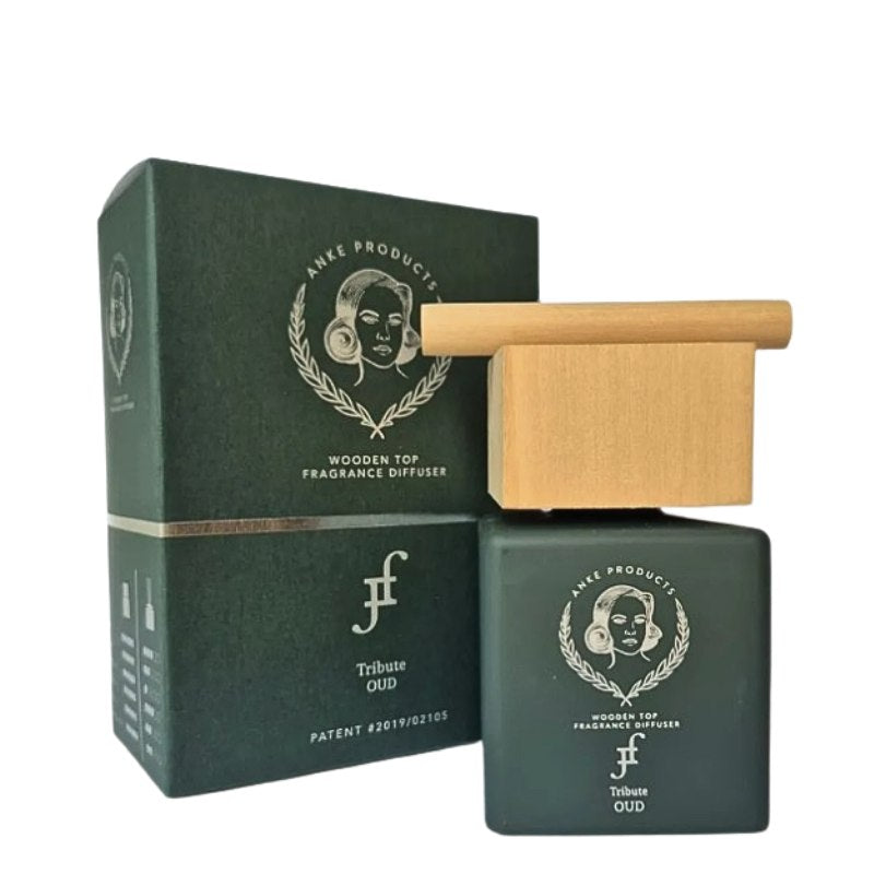 Green wooden top fragrance diffuser with packaging on a white background