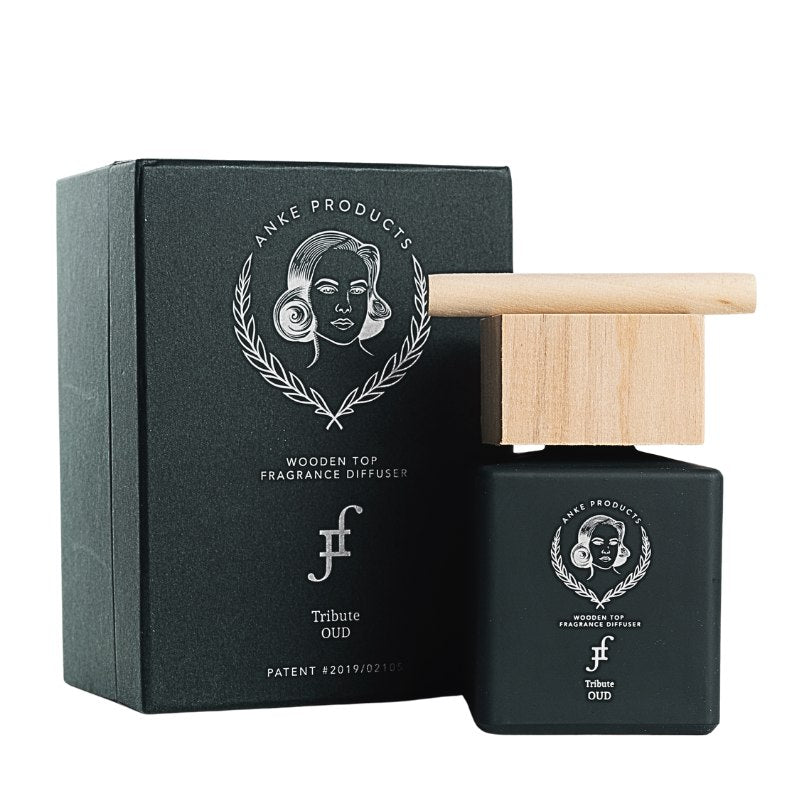 Black fragrance diffuser with wooden top and packaging on a white background