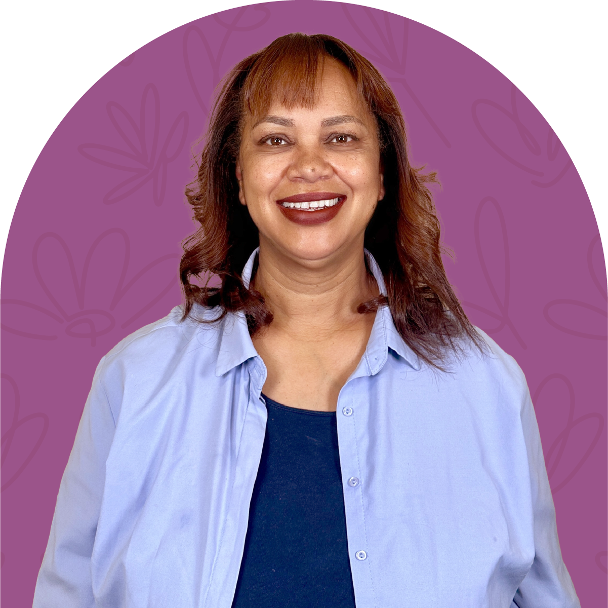 Portrait of Joy, a team member at Fabulous Flowers, smiling in a blue shirt against a purple background. MEET THE TEAM at Fabulous Flowers and Gifts.