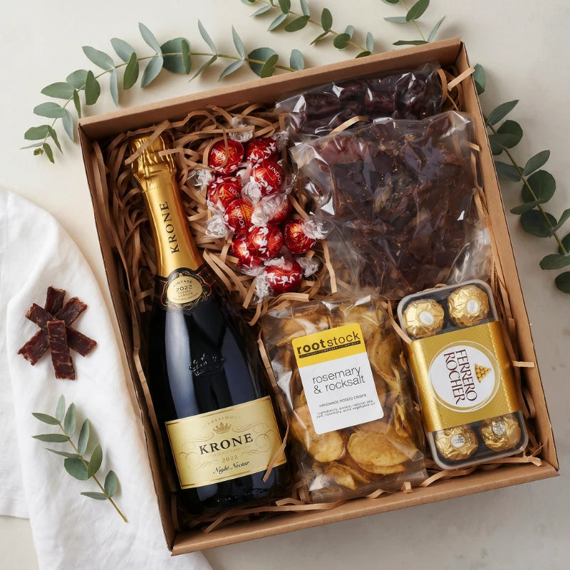 Krone Crisp Exquisite Snack Hamper flat-lay in kraft box with Krone Night Nectar, biltong, Rootstock chips, Ferrero Rocher and Lindt Lindor, Fabulous Flowers and Gifts