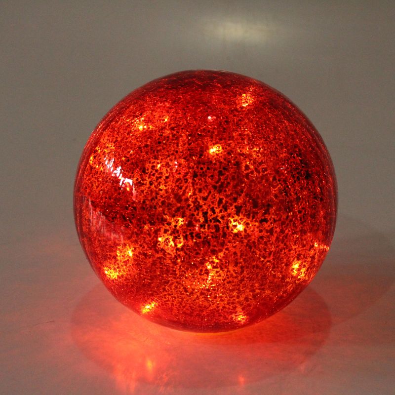 Red glass sphere with a textured surface on a gray background