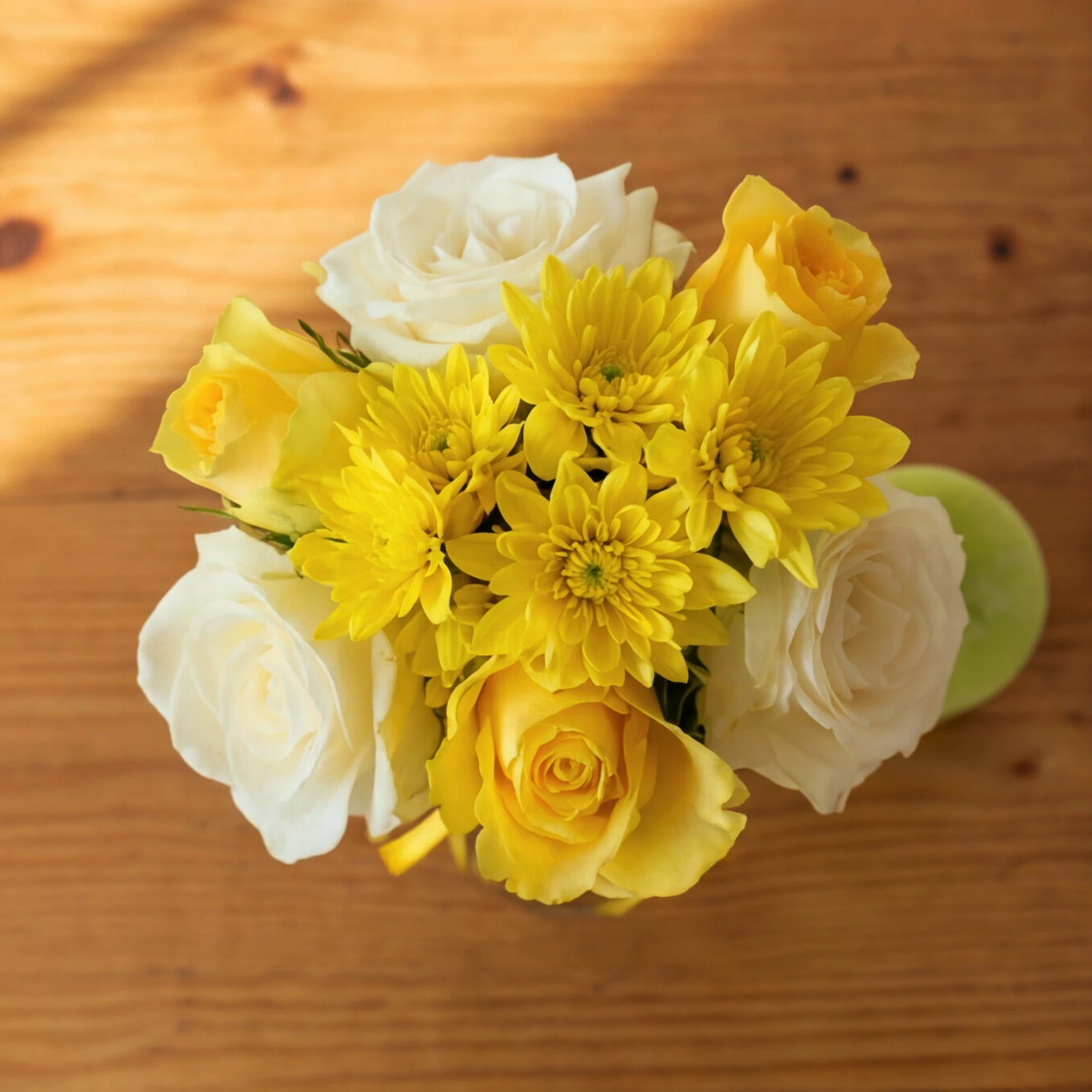 Top-down view of the yellow and cream rose posy from the Lather & Light candle gift set
