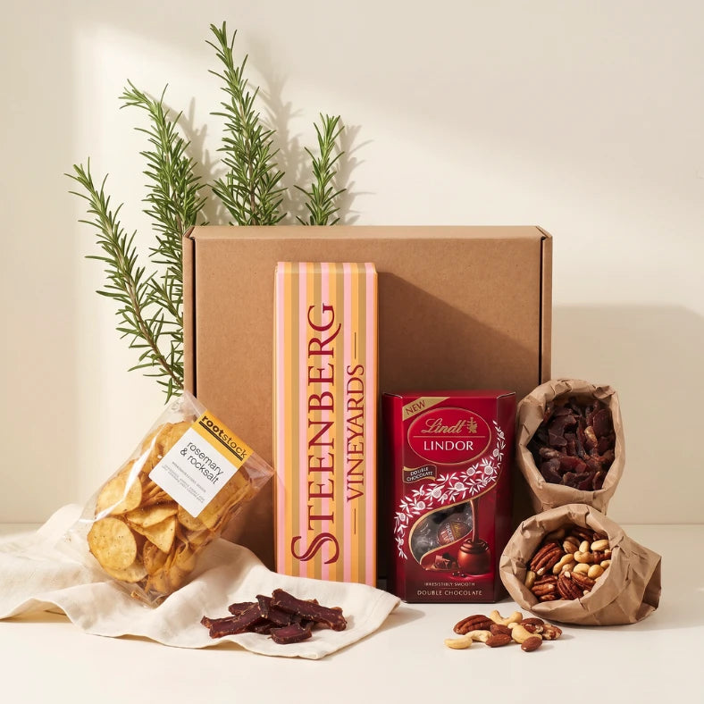 Let's Celebrate gift hamper styled with Steenberg wine, Lindt Lindor, biltong, mixed nuts and Rootstock rosemary chips, Fabulous Flowers and Gifts