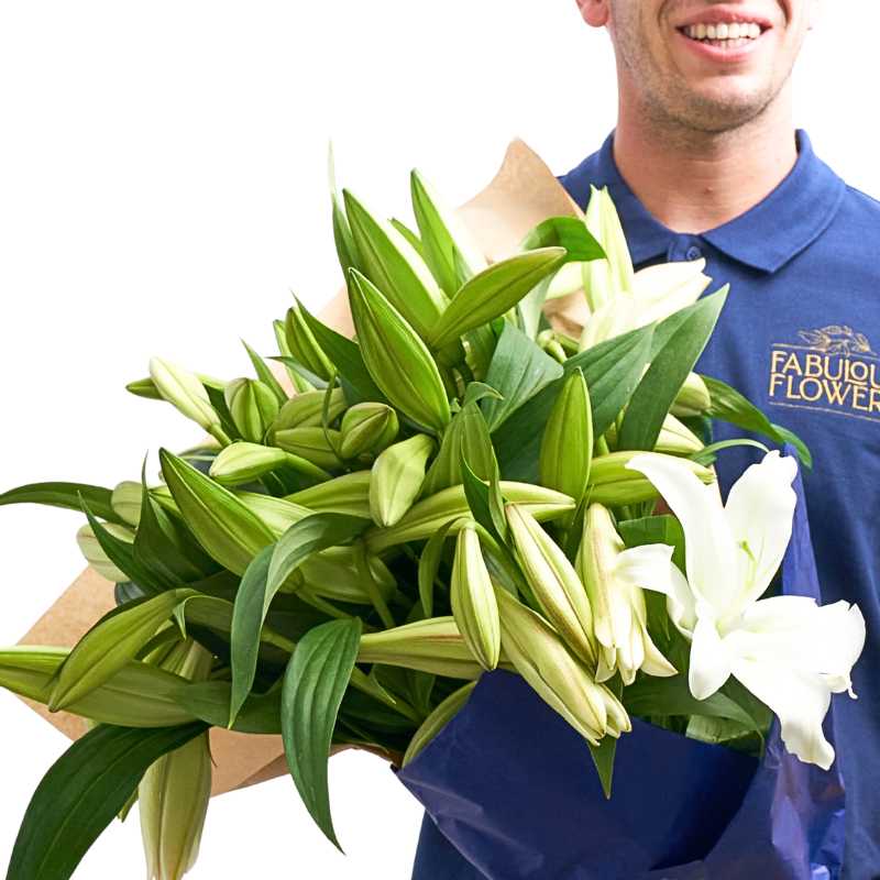 Close-up of Lily Bouquet showing white Casa Blanca lilies, buds and long green leaves