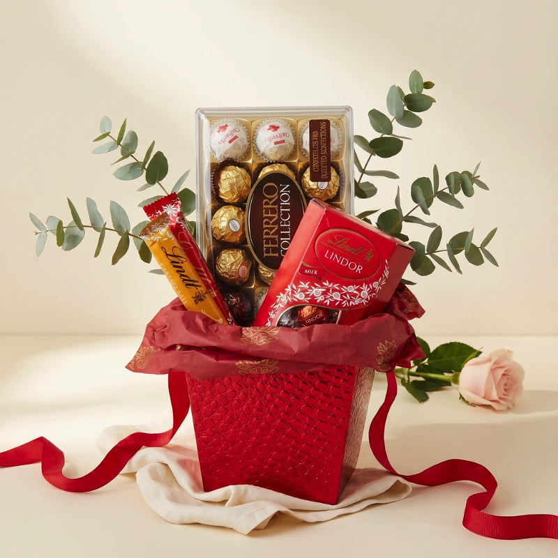 Lindt vs Ferrero gift styled in red embossed basket with Ferrero Collection, Lindt Lindor Milk and Lindt Caramel, Fabulous Flowers and Gifts