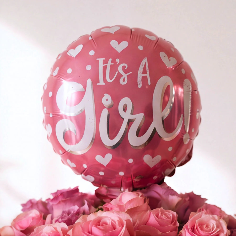 Close-up of the It's a Girl balloon above soft pink roses in the Little Sweetheart new baby girl arrangement