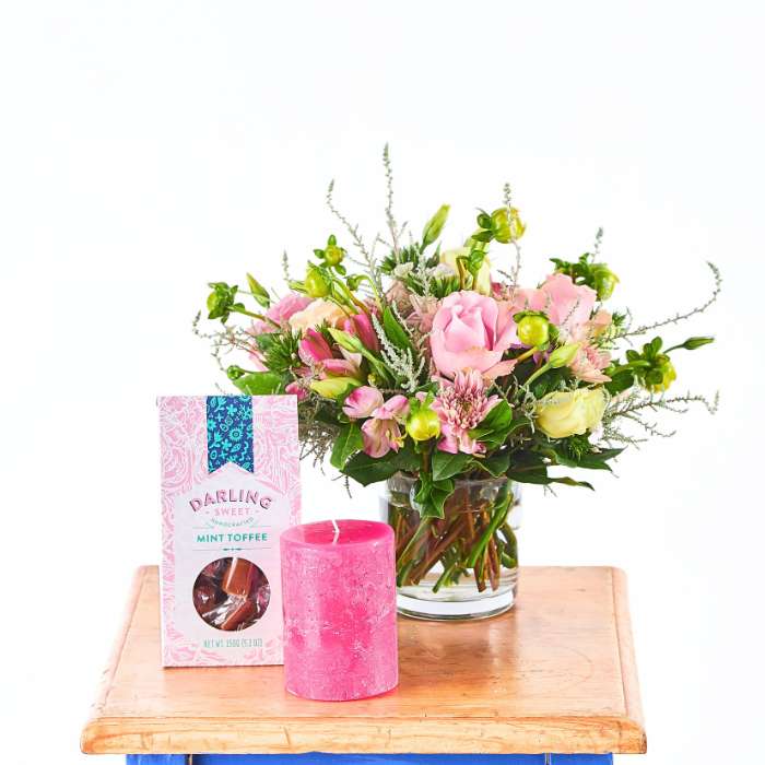 Love and Light Flower Gift Set with pink rose arrangement, pink pillar candle and Darling Sweet mint toffee on a wooden tray