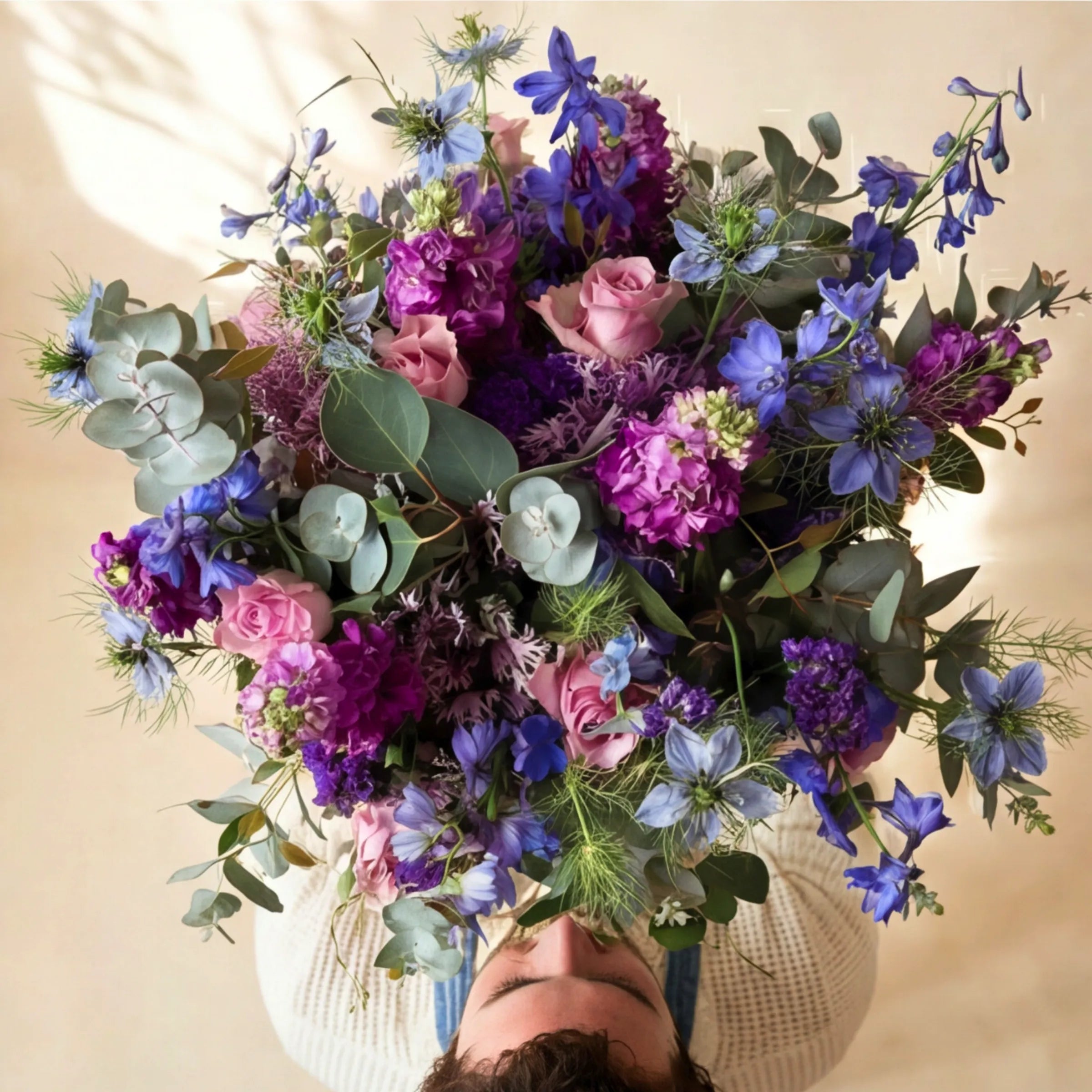 Purple and blue flower bouquet with lilac roses, delphinium, nigella and statice in soft light, Cape Town same-day delivery