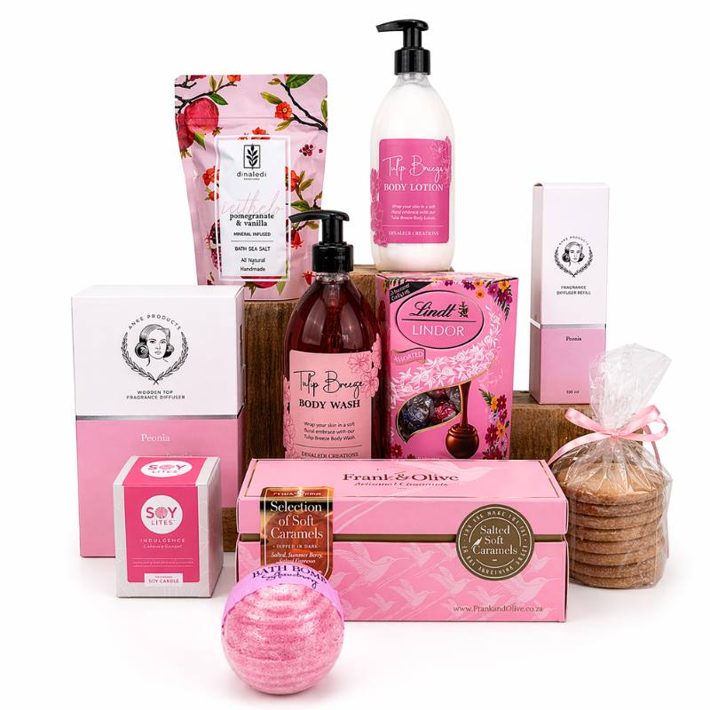 Collection of pink and white bath and body products on a white background