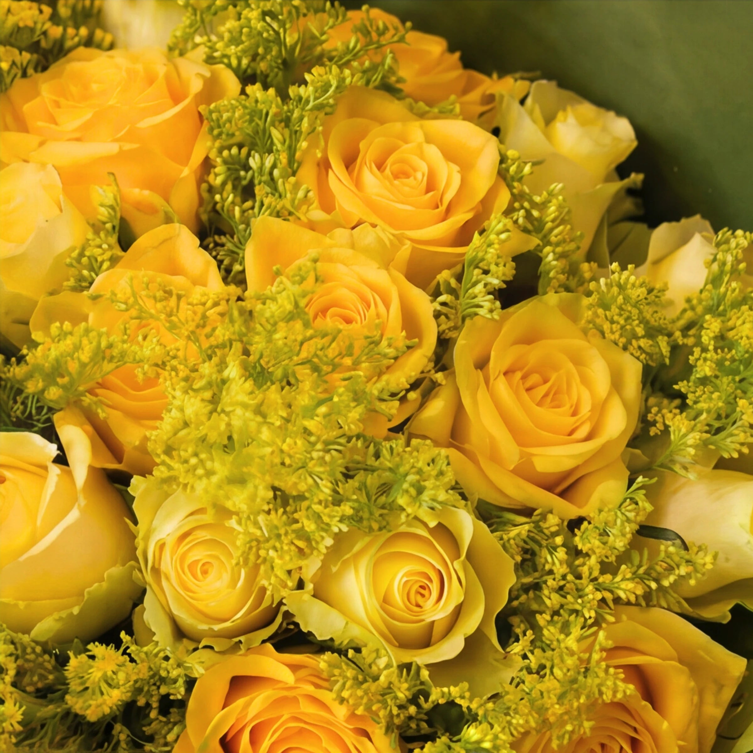 Close-up of yellow roses and golden solidago in the Meadowlark bouquet