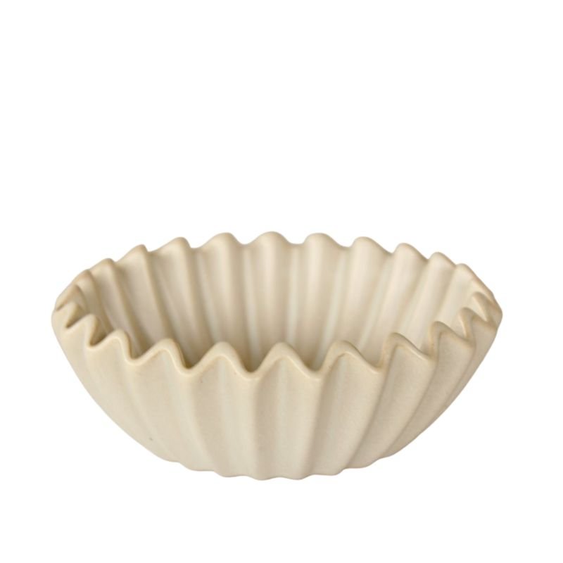 Beige ceramic bowl with wavy edge on a white background