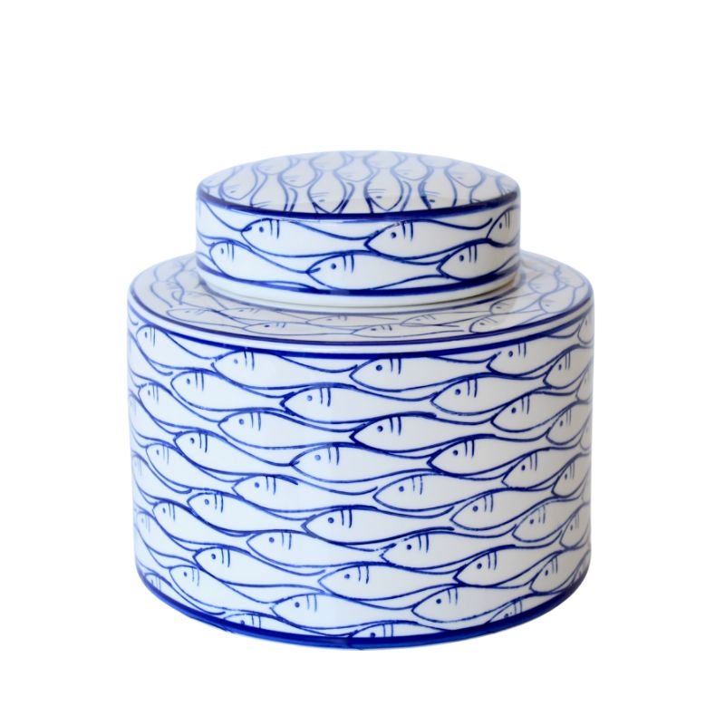 Ceramic jar with blue fish pattern on a white background