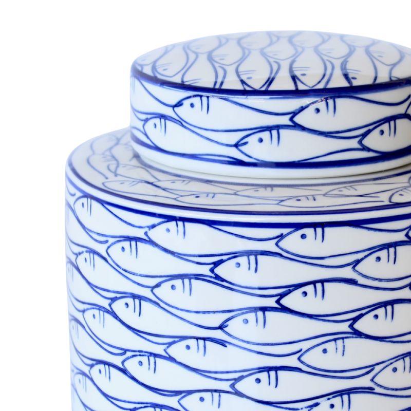 Ceramic jar with blue fish pattern on a white background