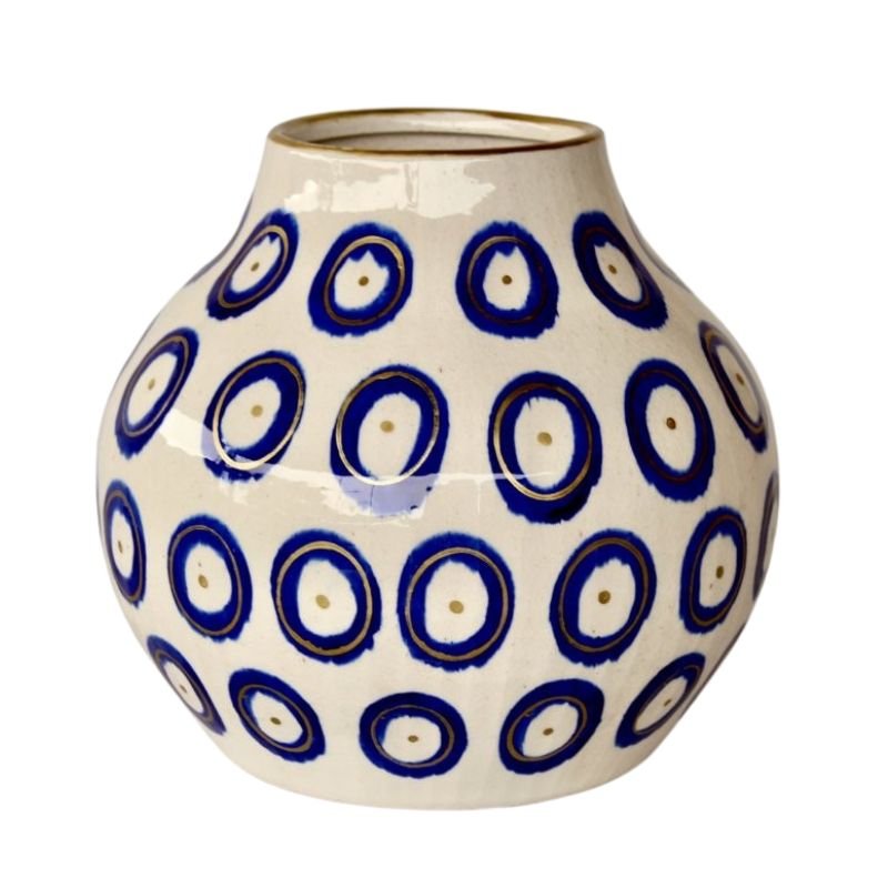 Ceramic vase with blue circular pattern on a white background