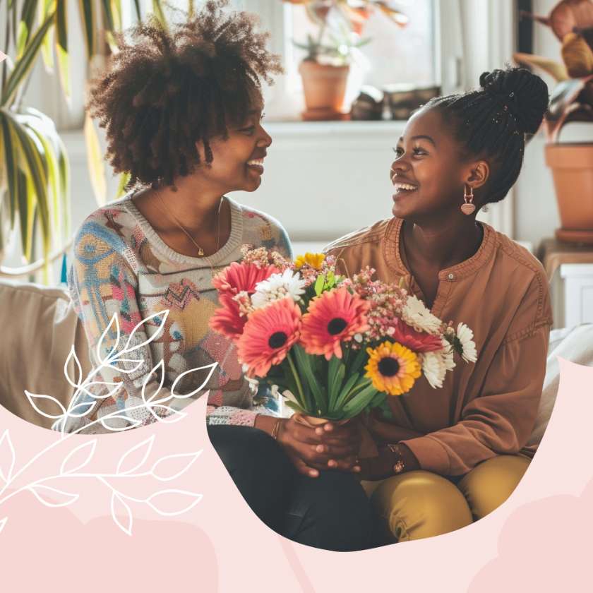 A heartwarming indoor moment between two generations, with a woman and a young girl exchanging smiles and a vibrant bouquet of gerberas and daisies, a scene that embodies the joy from Fabulous Flowers and Gifts.
