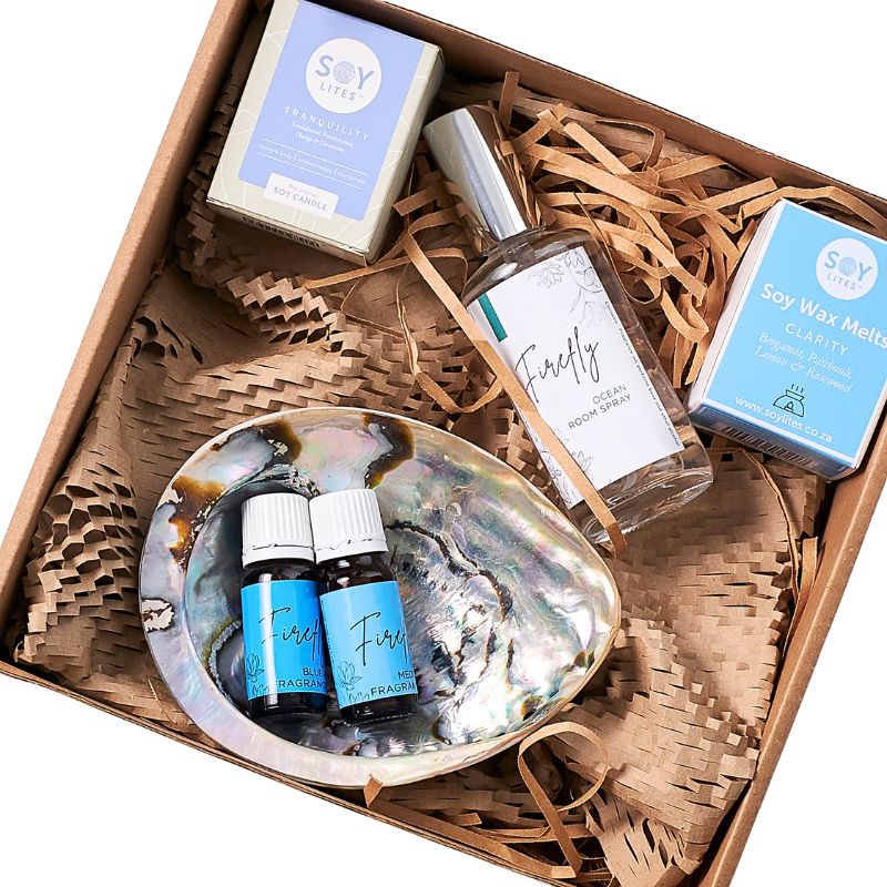 Gift set with soy wax melts, diffuser, and essential oils in a decorative box.