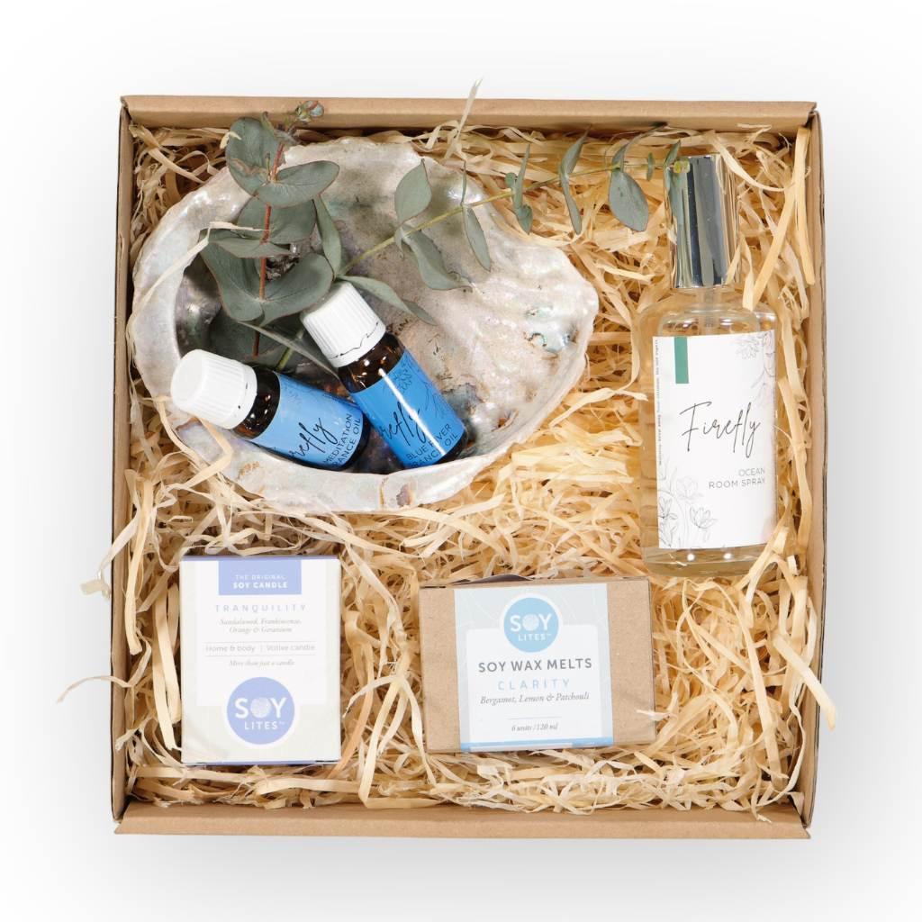 The Ocean Walks Gift Hamper is a lush assembly of gifts that includes:  Firefly Ocean Room Spray, which brings the fresh breeze of the sea right into your home Firefly Meditation and Blue River Essential Oils, ideal for a calming and rejuvenating aromatic experience SOY Lites Clarity Wax Melts and Tranquility Candle - Fabulous Flowers