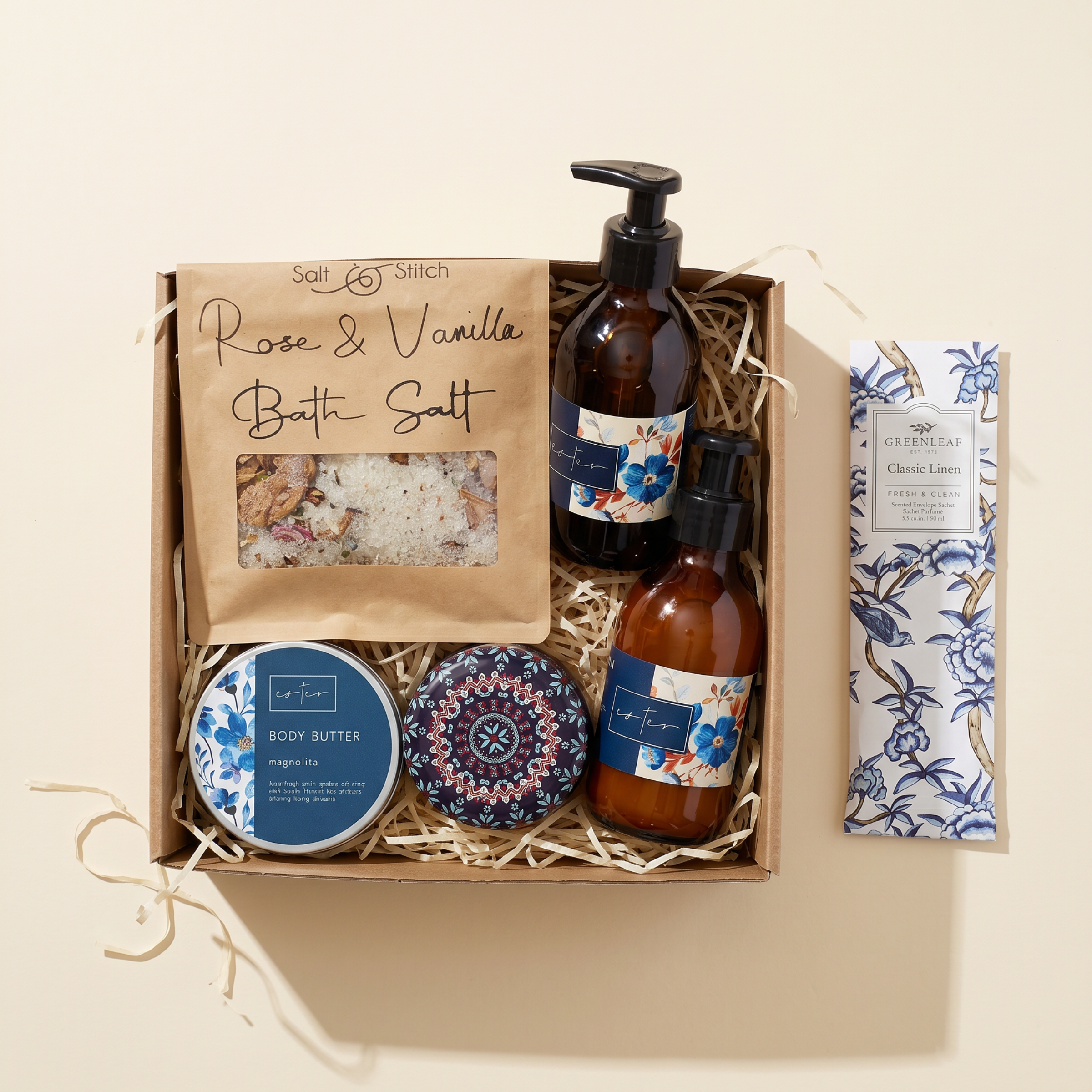 Opulent Oasis Gift Hamper flat lay with rose and vanilla bath salt, magnolia hand wash, body spray, body butter tin and Greenleaf linen sachet by Fabulous Flowers