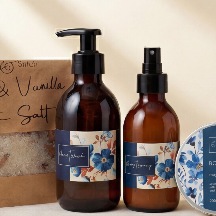 Magnolia hand wash and body spray amber bottles beside Salt and Stitch rose and vanilla bath salt in the Opulent Oasis Hamper
