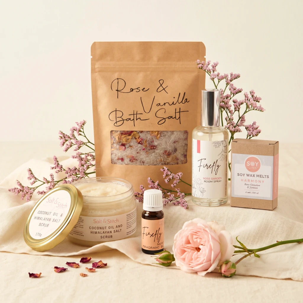 Pink Pamper gift hamper for her flat-lay with Salt & Stitch bath salt, Firefly rose room spray, wax melts and essential oil, Fabulous Flowers and Gifts