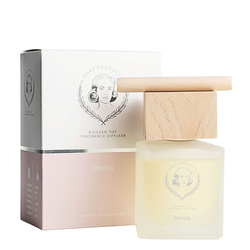 Fragrance diffuser with wooden top and packaging on a white background