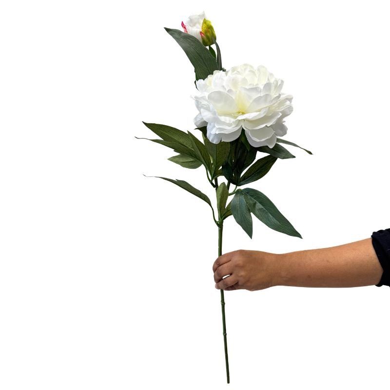 Hand holding a white artificial flower stem against a white background