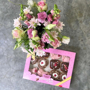 Indulgent hazelnut praline and white chocolate caramel doughnuts with lush flower arrangement | Fabulous Flowers and Gifts