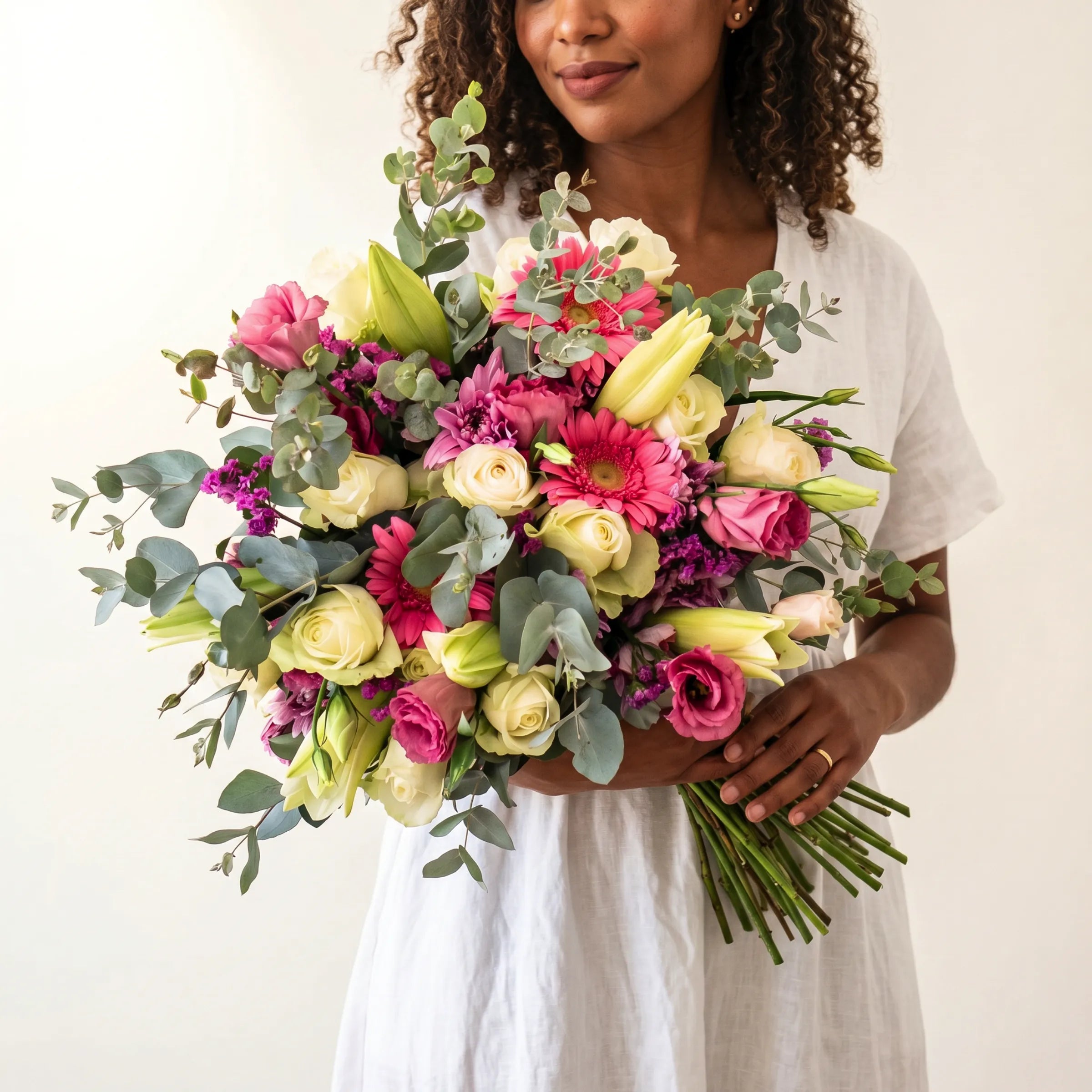Pink Expression Bouquet hand-tied with pastel pink roses, white roses, soft pink lisianthus, pink chrysanthemums, baby's breath and trailing eucalyptus, wrapped in signature kraft paper, Fabulous Flowers South Africa