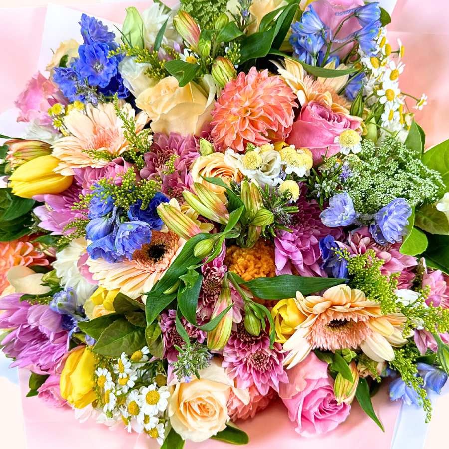 Bouquet of colorful flowers with a pink background