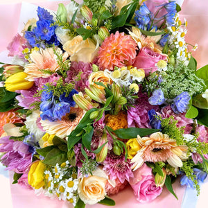 The Pink Passion Flower Bouquet, a vibrant and lush flower bouquet of pink, blue, yellow, and cream flowers with rich green foliage, embodying a spectrum of freshness and beauty, crafted by Fabulous Flowers and Gifts.