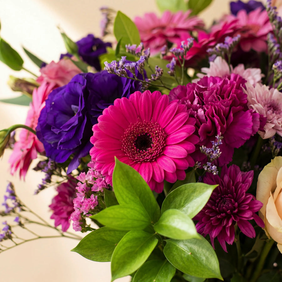 Pretty in Pink and Purple close-up with hot pink gerbera, magenta carnations, purple lisianthus and pink statice