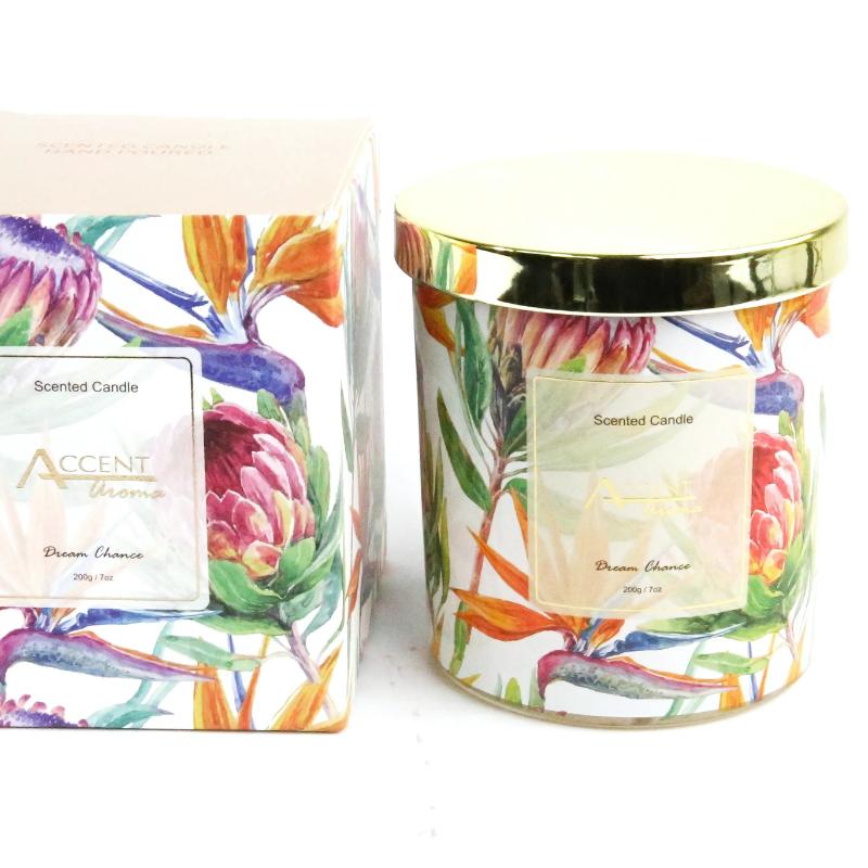 Scented candles with colorful protea floral design on a white background
