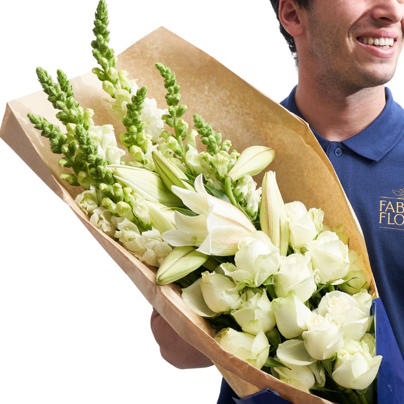 Man holding a bouquet of white flowers wrapped in brown paper, with 'Faber Flora' branding.