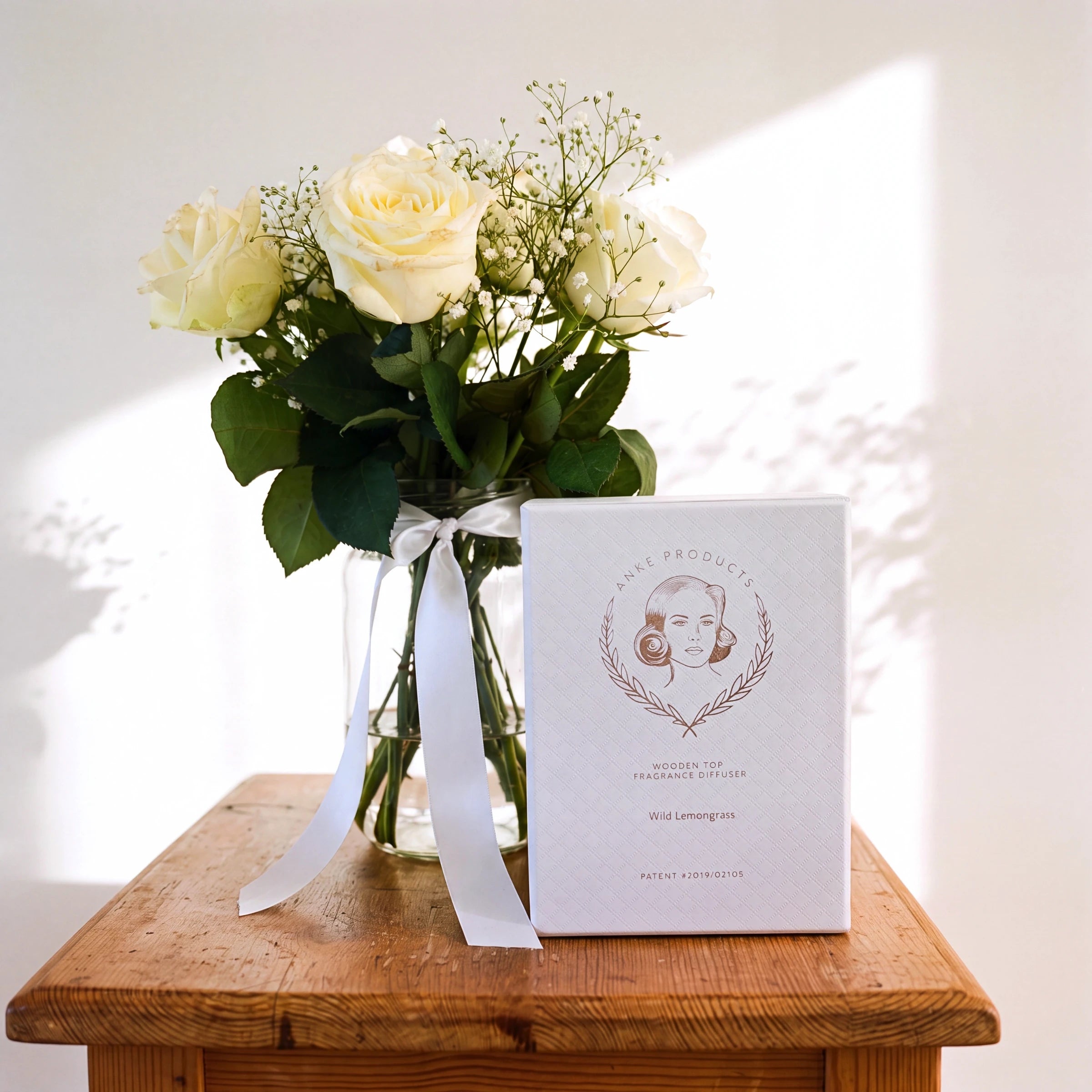 Pure Serenity white roses and Wild Lemongrass diffuser gift set in a glass vase