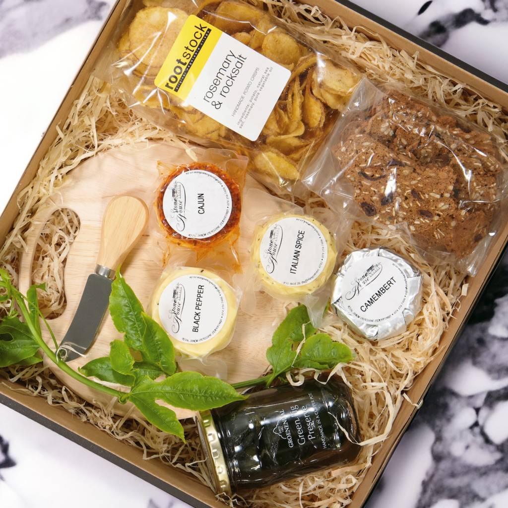 Scrumptious snack items like Picnic board and cheese knife, Rootstock Rosemary & Rocksalt Crisps, Green Fig Preserve, Karoo crackers, Mini Black Peper, Cajun, Italian Spice and Camembert Cheese Wheels for your picnic basket - Fabulous Flowers