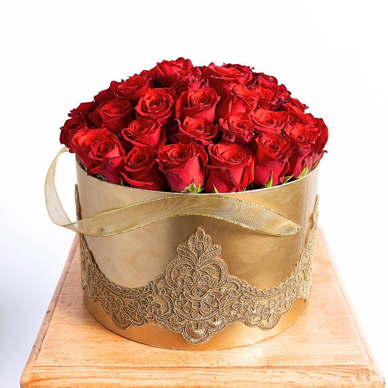 Gold box with red roses on a white background