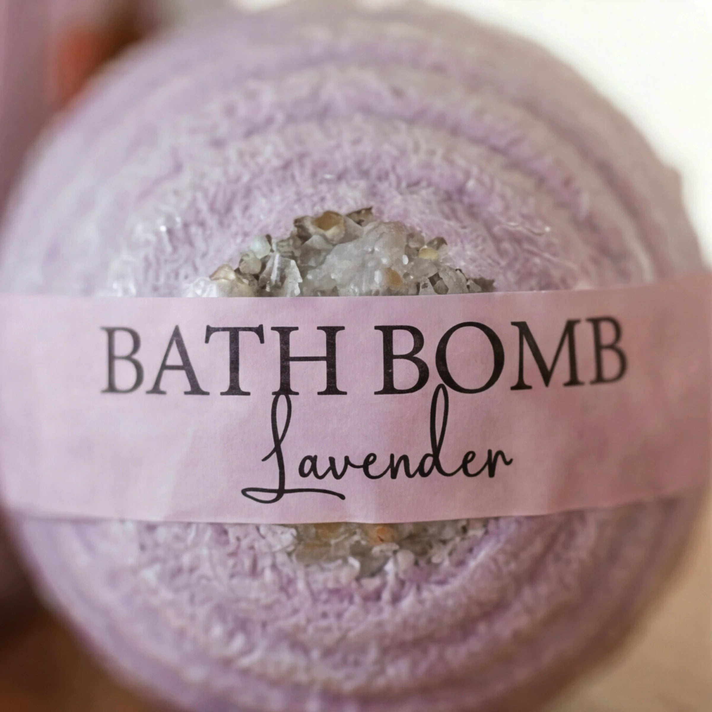 Close-up of the lavender bath bomb in the Rose & Repose spa gift set
